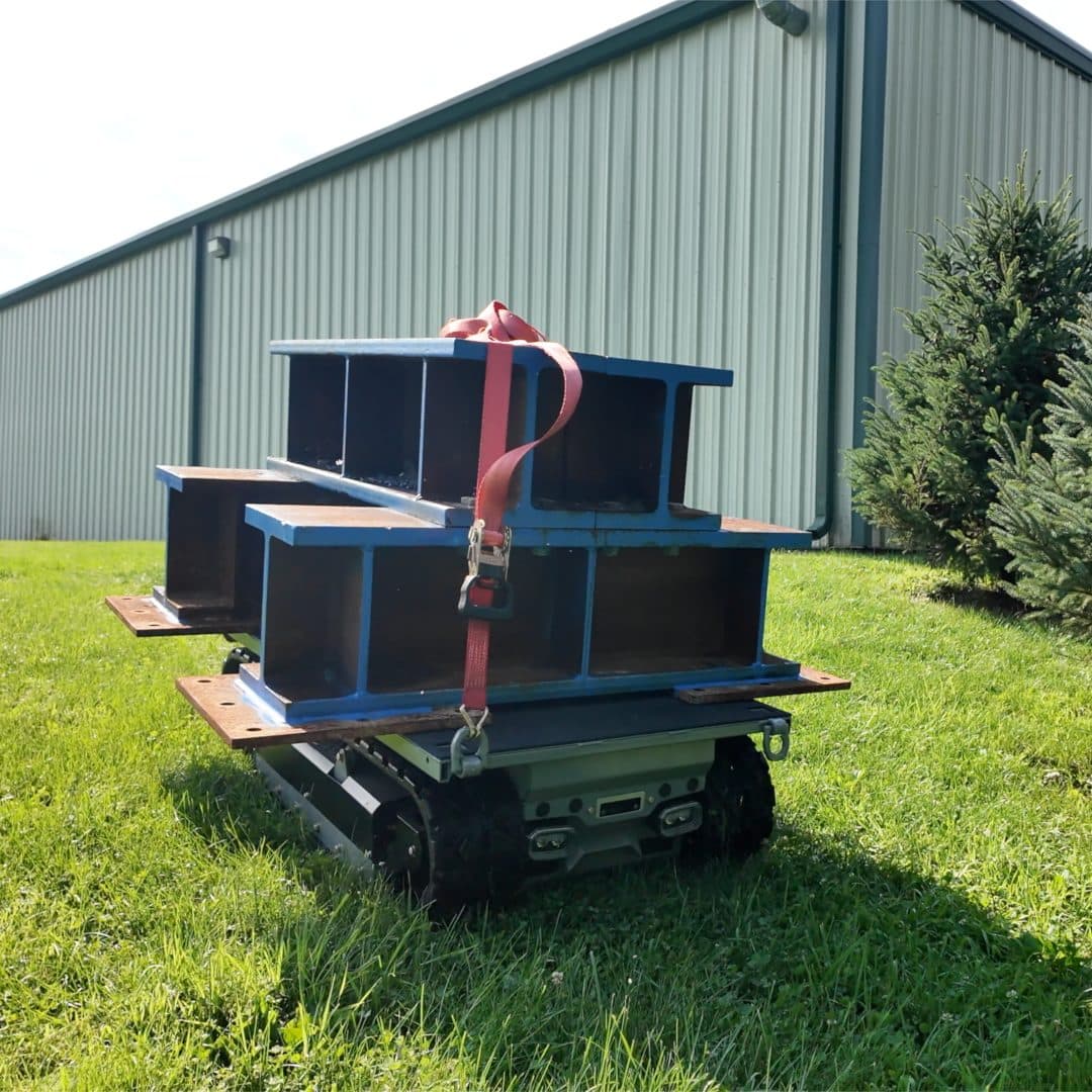 Site Runner carrying a strapped-down stack of steel beams