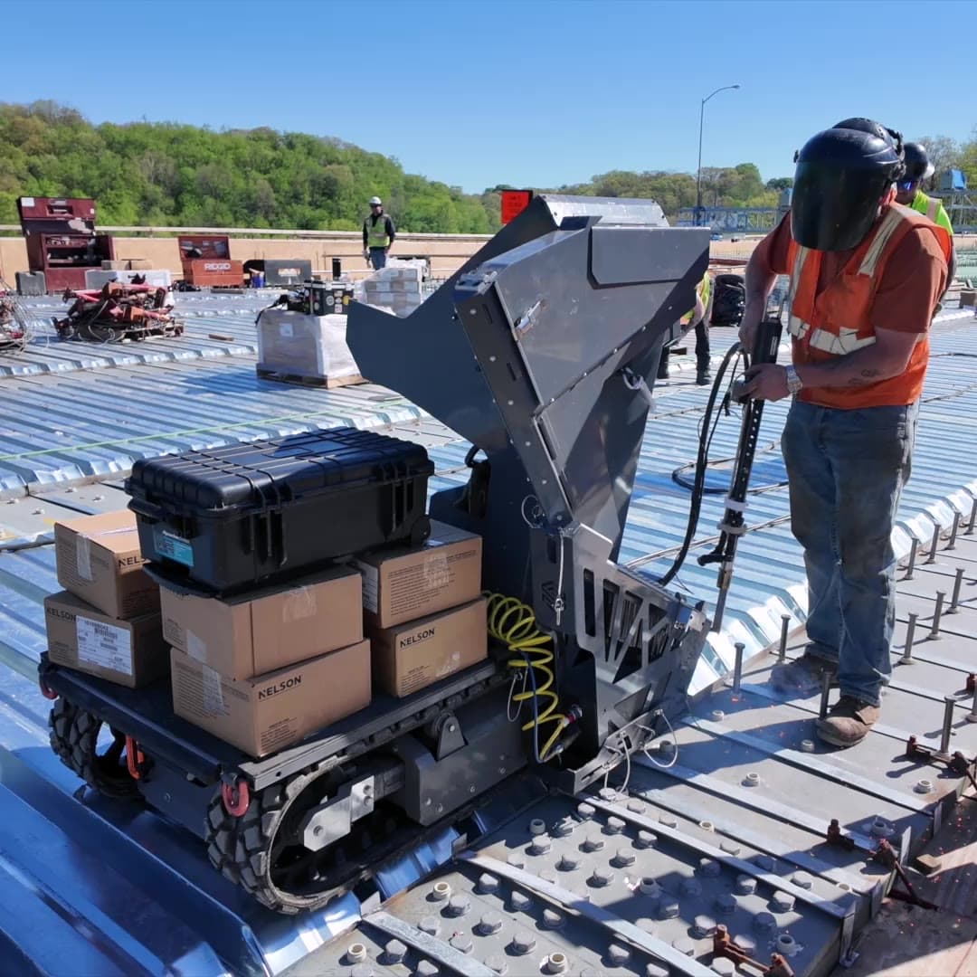 Site Runner fitted with the stud welding attachment on a bridge deck while an operator welds beside it