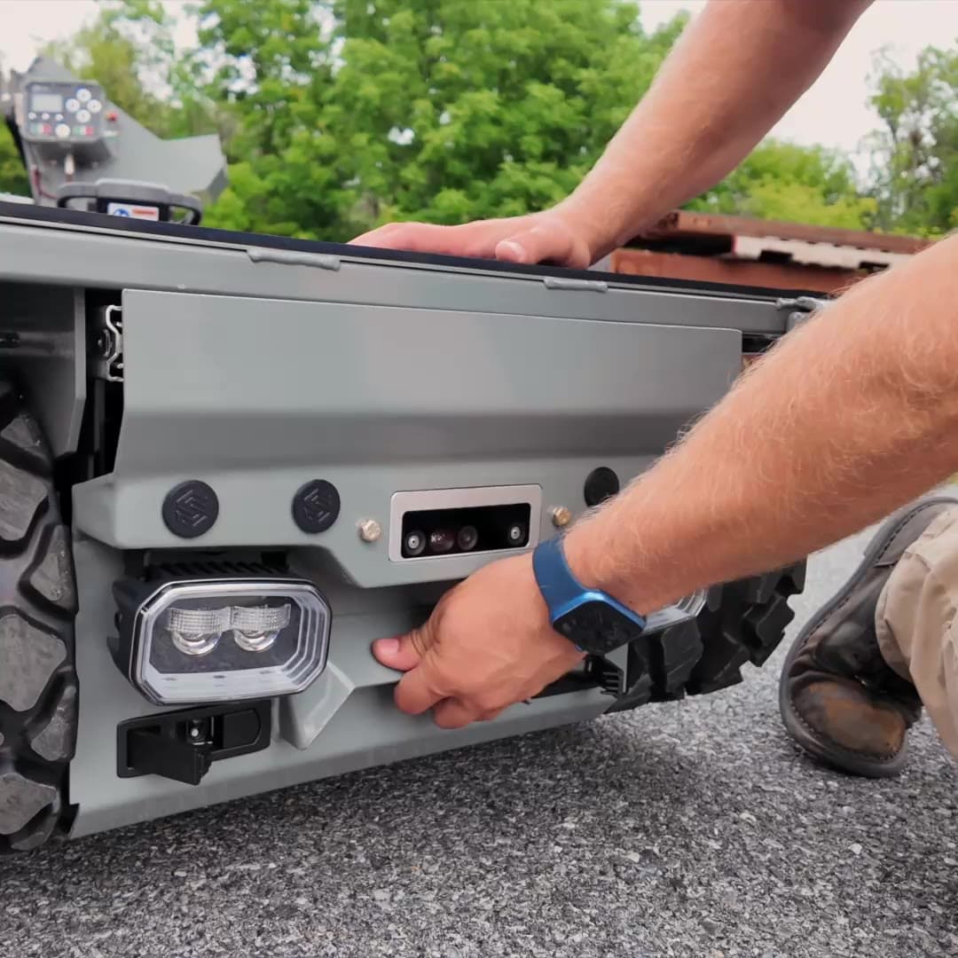 Operator sliding a battery pack out of the side of Site Runner
